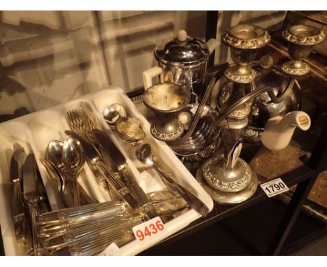 Shelf of silver plated flatware a candelabra and a three piece insulated tea service