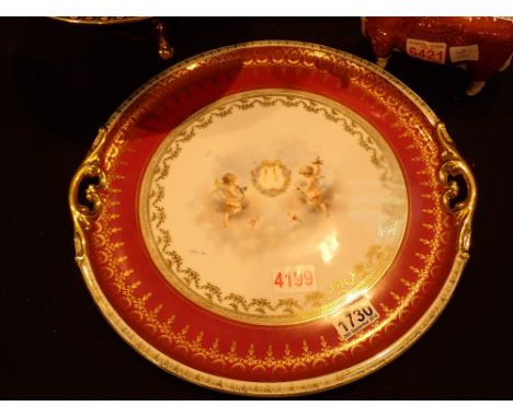 Circular Limoges style ceramic tray decorated with cherubs and gilt highlighted