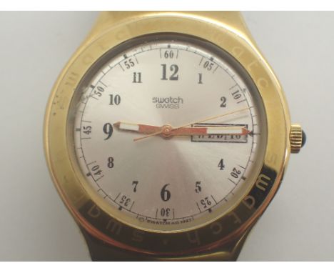 1997 Swatch day and date wristwatch  CONDITION REPORT: This item is working at lotting.