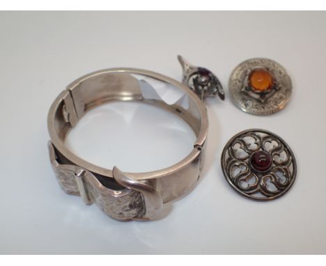 Three Scottish hardstone brooches and an unmarked buckle bangle