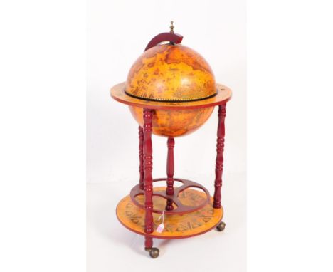 A 20th Century vintage mahogany veneer zodiac globe cocktail drinks cabinet / trolley. Having a hinged lid to globe top, open