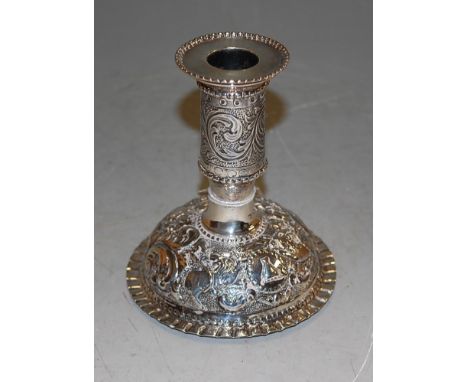 A late Victorian silver and embossed table candlestick, the whole finely embossed with wild animals amidst scrolls and foliag