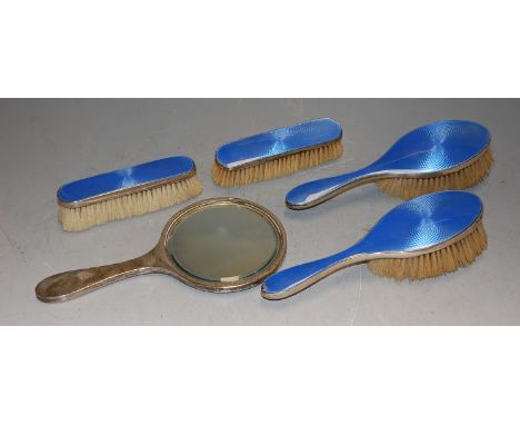 Art Deco silver and enamel backed dressing table wares comprising hand mirror, two hair brushes, and two clothes brushes, mak