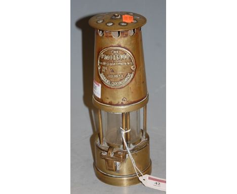 A brass miners safety lamp by the Protector Lamp and Light Co Ltd makers of Eccles, Manchester; together with a hand bell (2)