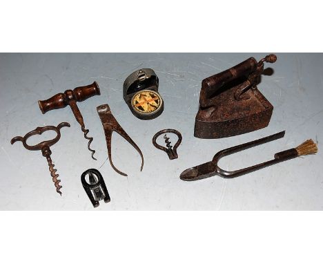 A cast iron flat iron; three corkscrews; and a military compass etc