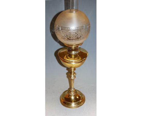 A late Victorian polished brass oil lamp, having acid etched shade, h.68.5cm