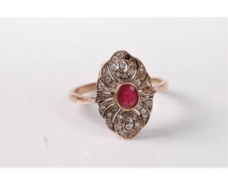 An early 20th century 9ct ruby and diamond ring, the central round ruby in a collet mount, set to a marquise shaped plaque se