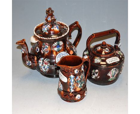 A Victorian bargeware teapot 'A present from a Friend'; one other smaller (both a/f); and a jug named for Arthur 1913 (3)