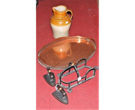 A large silver plated galleried tray, well-worn; a large earthenware strap handled jug; 19th century flat irons; and a wrough