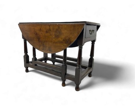 19th century oak extending dining table, oval drop-leaf top over single end drawer, on turned supports united by stretchers, 