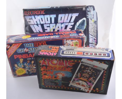 Vintage battery operated toys and games, including Ghostbusters pinball games, Atomic Arcade pinball, Entex Space Invader, Pa