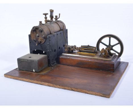 A well built stationary engine, mounded on wooden base, with 4inch flywheel, 35cm by 27cm base. 