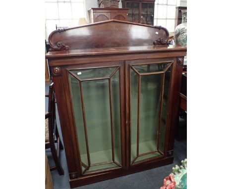A WILLIAM IV MAHOGANY BOOKCASE WITH CARVED BACKSTAND and button-turned terminals to the sides, originally open, fitted with l