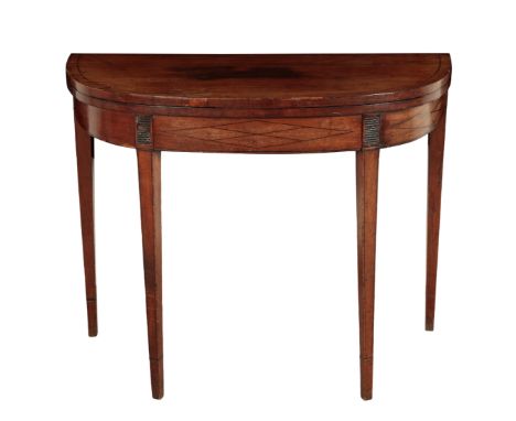 A MAHOGANY CARD TABLE early 19th century, the hinged top opening to a baize lined interior, on tapering, ebony-strung, block 