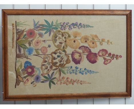 An embroidered silk tapestry of lupins and hollyhocks, dated October 1952 signed DNB