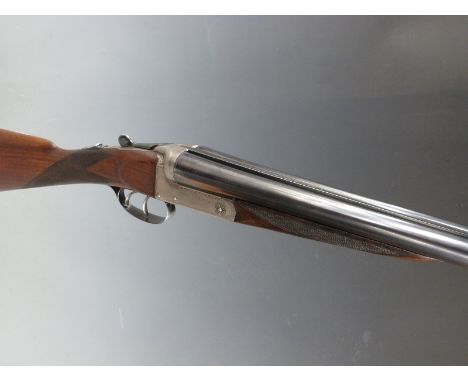 Thomas Wild 12 bore side by side shotgun with named and border engraved locks, chequered grip and forend, double trigger, vac