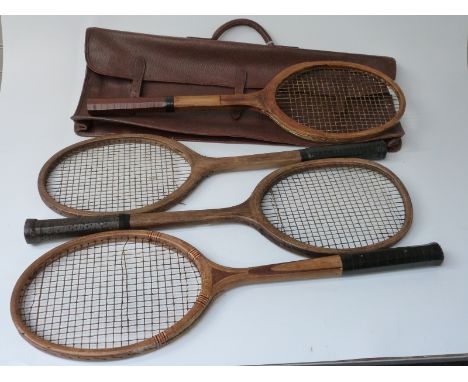 Four vintage tennis rackets and a leather carry case.&nbsp;