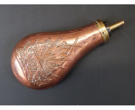 Copper and brass powder flask with embossed decoration of a cannon, guns and flags in the American style to both sides, 18cm 