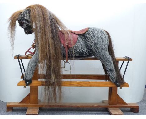 Vintage rocking horse with grey fur, brown mane and tail, glass eyes, leather saddle and wooden base, 115cm long.&nbsp;&nbsp;