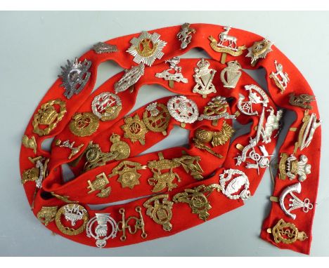 A collection of British Army cap badges including South Wales Boarders, Fife &amp; Forfar Yeomanry, Gloucestershire Regiment,