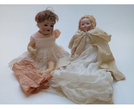 Two Armand Marseille bisque headed dolls, one with closed mouth, weighted blue eyes, soft body and composite limbs, marked to