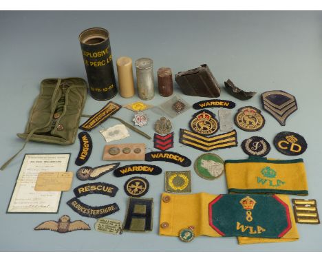 A small collection of militaria including Women's Land Army (WLA) cloth arm bands, cloth insignia, RCAF buttons etc