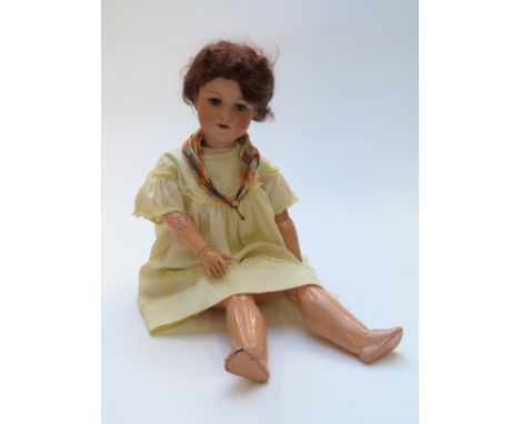 Armand Marseille bisque headed doll with open mouth, weighted brown eyes, brown hair, articulated composite body and yellow l