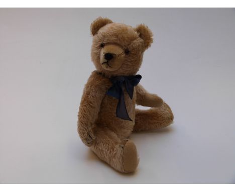 English Teddy bear, possibly Farnell or Steiff, with blonde mohair, shaved snout, glass eyes, stitched claws, mouth and nose,