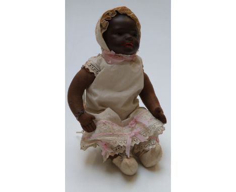 Heubach Koppelsdorf bisque headed black doll with open mouth, weighted brown eyes, and jointed soft body, marked to the back 