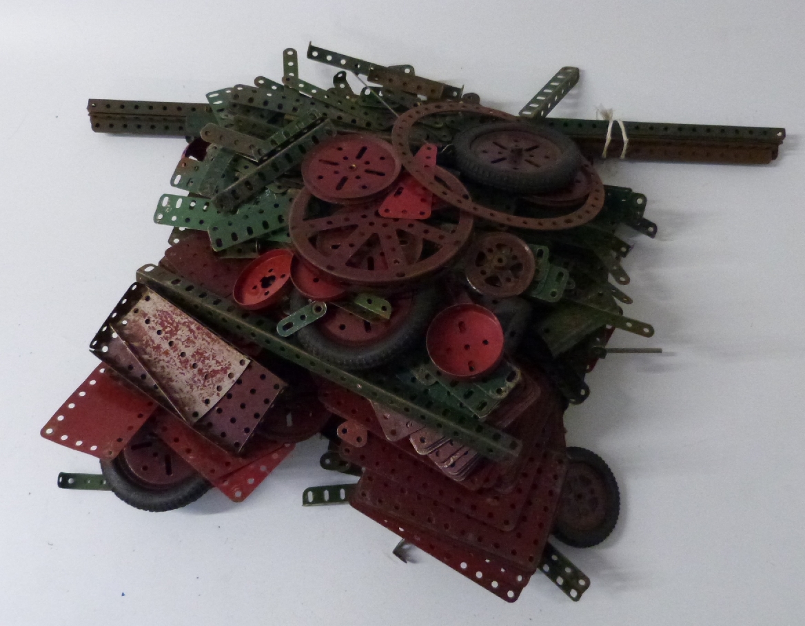 A collection of Meccano motors, wheels, gears and parts, some in