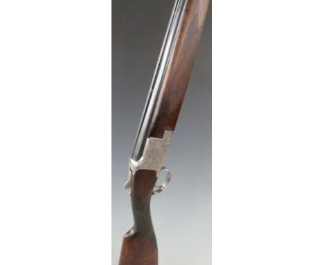 Browning B2 12 bore over and under ejector shotgun with engraved scenes of birds to the lock, chequered grip and forend, all 