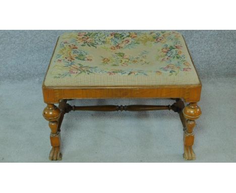 An early 20th century William and Mary walnut footstool with a tapestry drop in seat. H.41 W.66 D.56cm 