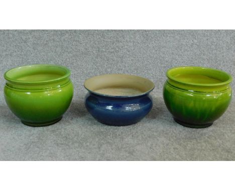 A pair of antique green Bretby pots with makers stamp to base and numbered '14220' with another blue art pottery planter. H.1