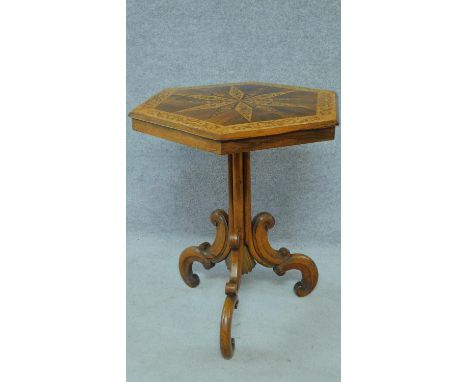 A mid Victorian bird's eye maple and rosewood centre table with profuse Arabesque inlay with tilt top action on carved tripod