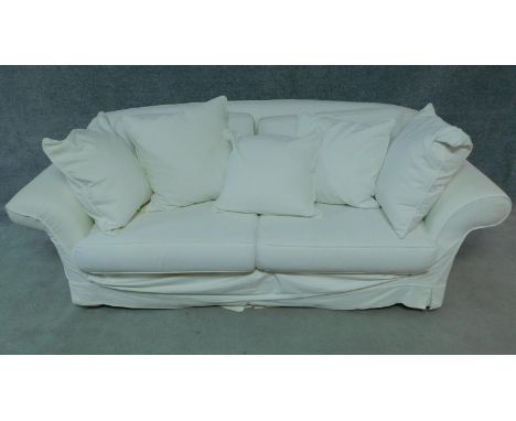 A contemporary two seater sofa in loose light cream covers by Mazzoti. H.80 W.215 D.93cm 