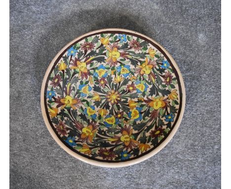 A large ceramic Persian shallow bowl with allover floral pattern. Dia.36cm 