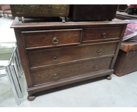 An early 20th Century oak chest of two over two drawers