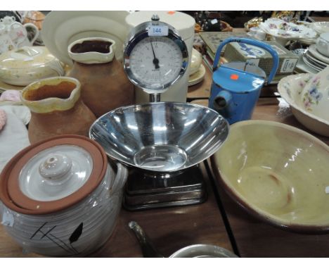 A kitchen scale set by Salter and two terracotta jugs