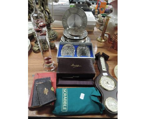 A selection of plated tablemats, coasters, also card games and barometer