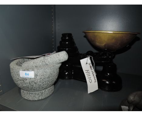 A cast kitchen scale set and mortar and pestle