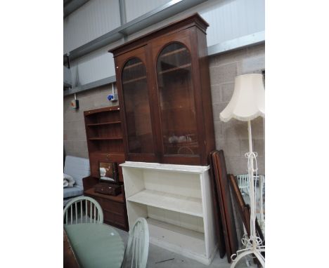 A part 19th Century bookcase with painted open shelf base