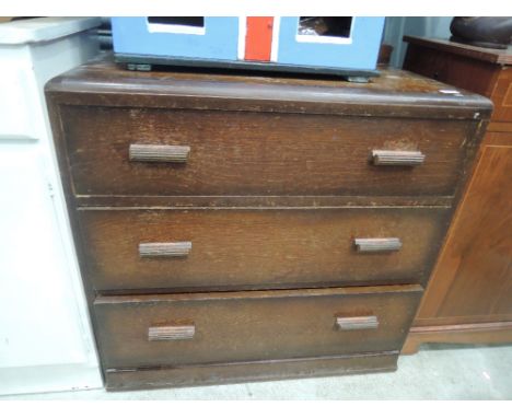 An early to mid 20th Century oak bedroom chest of three long drawers