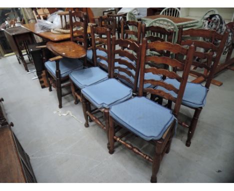 A set of 7 (6+1) 20th century part elm vernacular kitchen dining chairs having wave ladder backs, with rush seats and turned 
