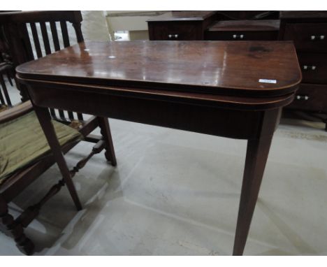 A 19th century mahogany tea table having fold over top on tapered gate legs