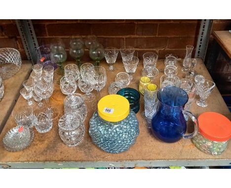 SHELF OF MIXED GLASSWARE INCL; DRINKING GLASSES, SUGAR POTS, WINE GLASSES &amp; 2 POTS F DECORATIVE GLASS BEADS