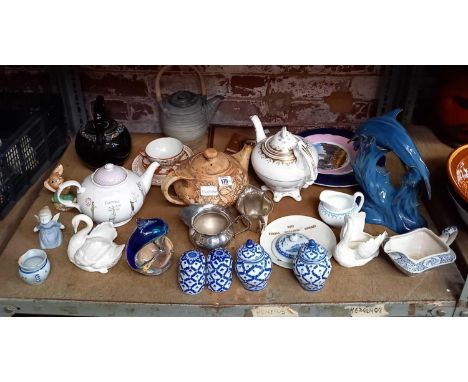 SHELF OF VARIOUS CHINAWARE INCL; TEAPOTS, GLASS DOLPHIN PAPERWEIGHTS, DOLPHIN ORNAMENTS &amp; JARS