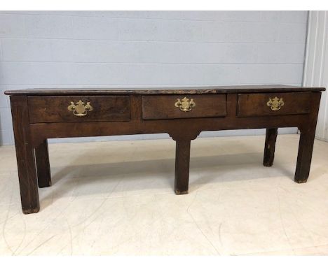 18th Century low oak console / table with three drawers and brass handles, approx 170cm x 40cm x 60cm tall (A/F)