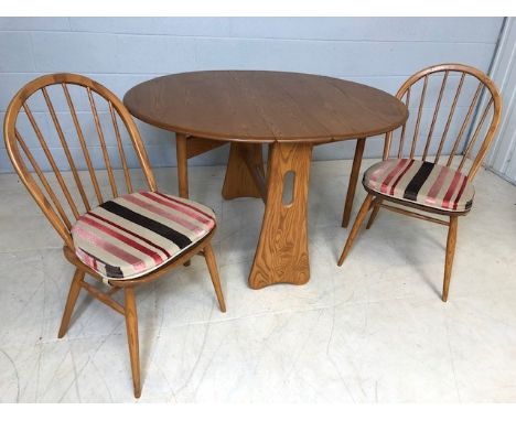 Blonde Ercol gateleg table, approx 121cm x 106cm extended, along with two Ercol stick back dining chairs