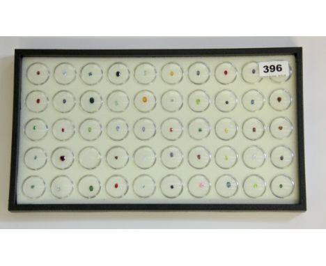 A tray containing 50 boxes of unmounted precious and semi-precious stones, including sapphire, ruby, peridot, etc.