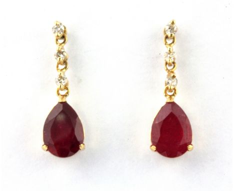 A pair of 18ct yellow gold (stamped 18k) drop earrings set with a pear cut ruby and brilliant cut diamonds, L. 1.6cm.